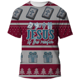 Red and white Christmas sweater-style shirt with text 'Jesus is the Reason' in bold letters featuring Bible, cross, dove, gift and Christmas tree graphics