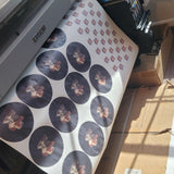 Close-up of vibrant ready to press custom sublimation transfers with a heat press, emphasizing quality and local Houston pickup service for small businesses.