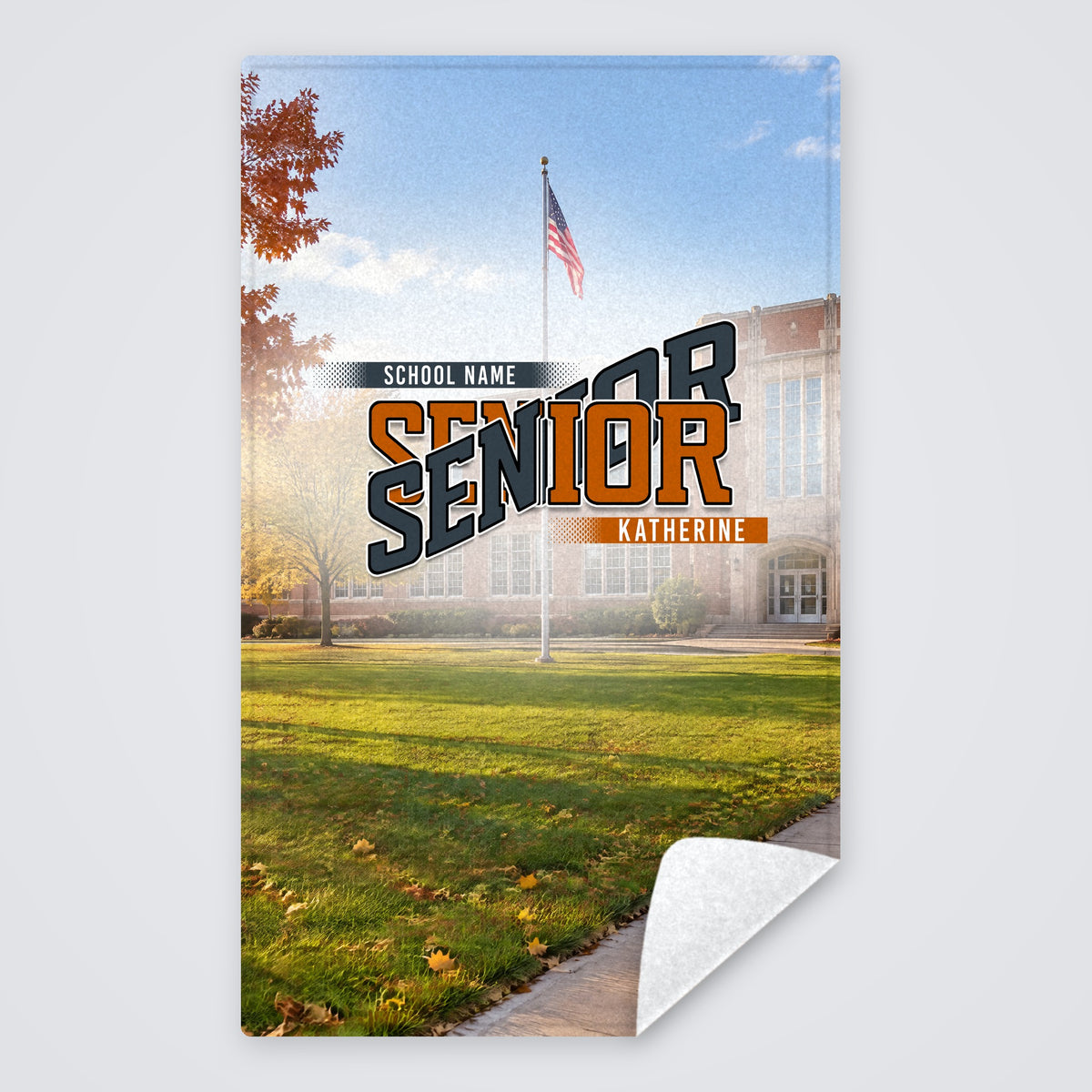 School Yard class year Senior towel with a school photo behind the burnt orange and charcoal design, rally towel with the corner folded to show the white back