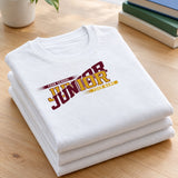 Folded stack of white custom Junior class year shirts in maroon and gold school colors on a wood table