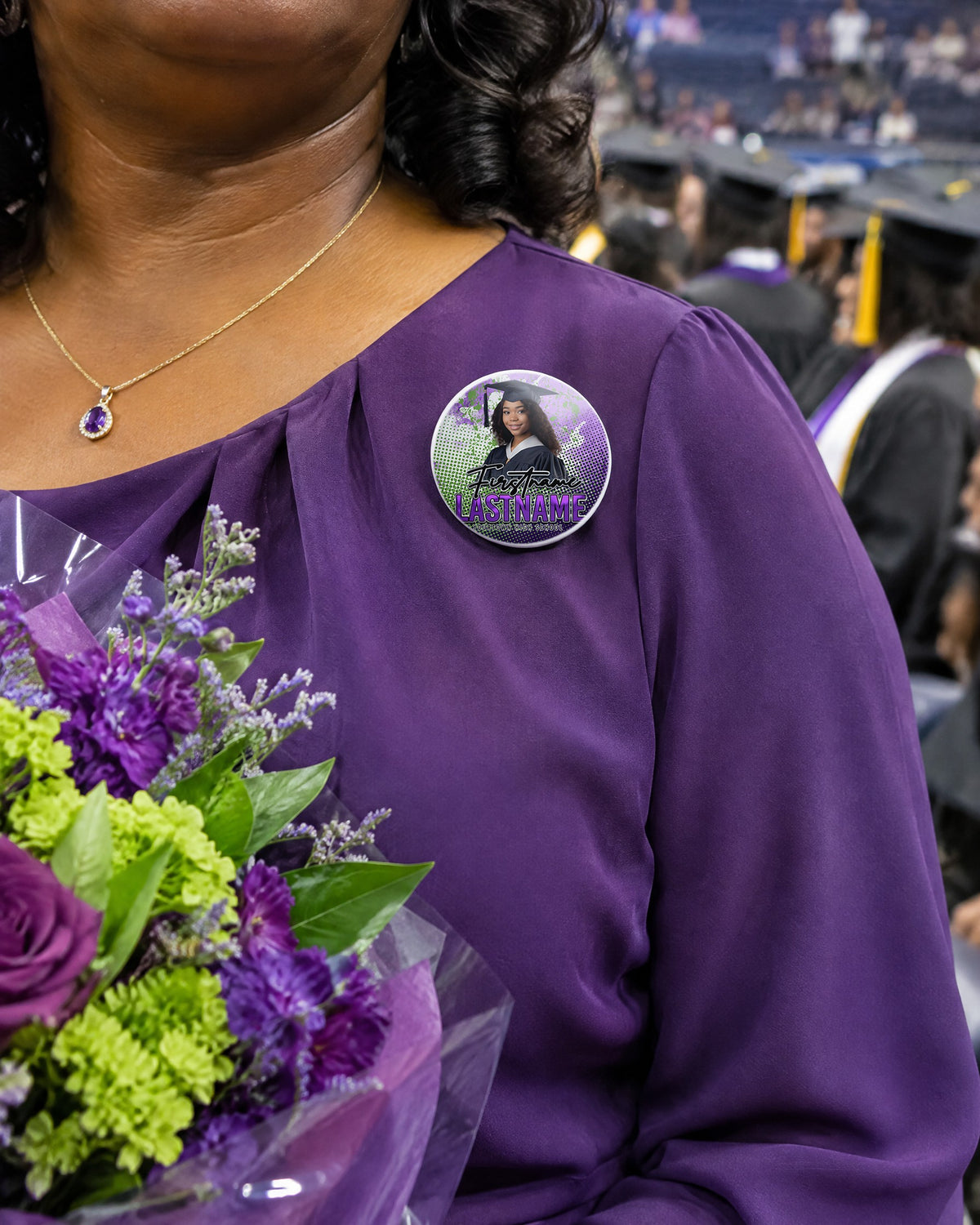 Custom graduation photo pin button worn by a proud mom at a college graduation ceremony