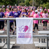 Awareness rally towel hanging on a bleacher rail at a walk event