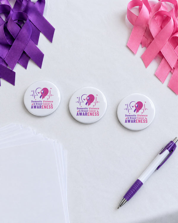 Domestic Violence and Breast Cancer Awareness sublimation buttons on a fundraiser table with purple and pink ribbons