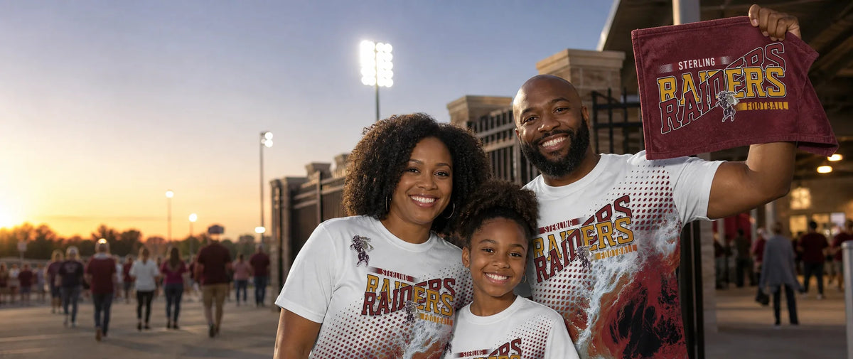  Family in matching maroon and gold all over game day shirts outside the stadium gate, dad holding up a rally towel