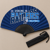 Flat lay of an open navy game day clack fan with black ribs and a volleyball team design, beside its black drawstring bag.