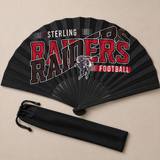 Flat lay of an open black game day clack fan with black ribs and the football team design in red and black, beside its drawstring bag.