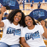 Two moms in volleyball game day shirts holding open clack fans in navy and light blue in the gym bleachers.