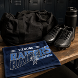 Navy game day rally towel with a football team design folded on a locker room bench beside a gym bag and cleats.
