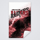 Red and black game day rally towel with the Raiders football design, corner folded to show the white back