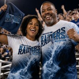 Mom and dad cheering in the stadium stands on a Friday night, both wearing navy and light blue all over game day shirts with a horse and rider mascot.