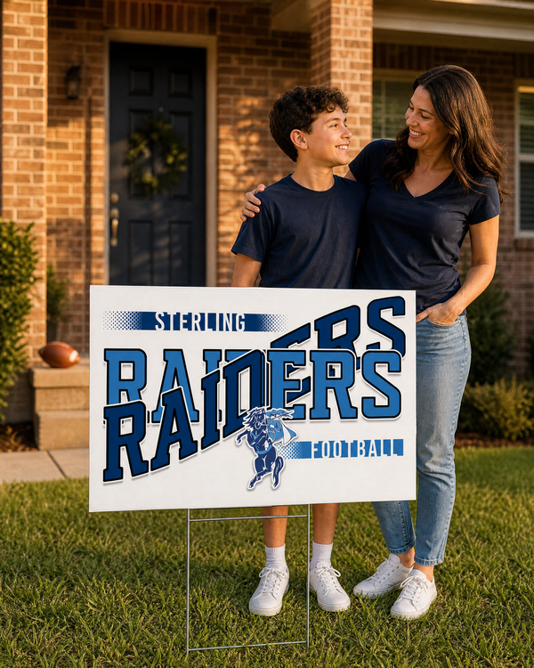 Navy and light blue game day yard sign on a stake in a front yard by a brick home at golden hour, with a mom and her son.