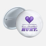 Love Shouldn't Hurt 2.25 inch pin button with a purple heart and ribbon