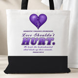 Love Shouldn't Hurt tote bag, white with a black bottom panel and black handles, purple heart and Psalm 147:3