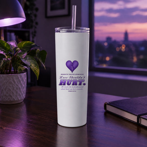 Love Shouldn't Hurt domestic violence awareness tumbler on a desk in purple evening light