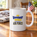 My Different World Started in the U.S. Air Force coffee mug with hot coffee on a wooden kitchen table, with reading glasses, a newspaper and a small American flag