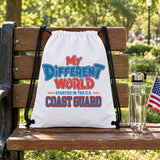 My Different World Started in the U.S. Coast Guard white drawstring backpack hanging on a wooden park bench, with a water bottle and a small American flag
