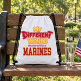 My Different World Started in the U.S. Marines white drawstring backpack hanging on a wooden park bench, with a water bottle and a small American flag