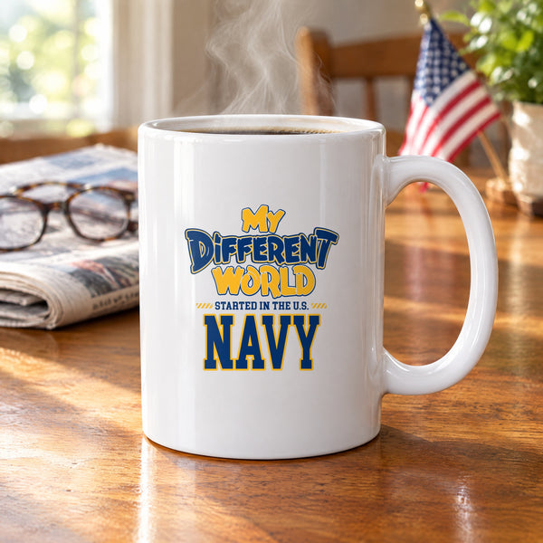 My Different World Started in the U.S. Navy coffee mug with hot coffee on a wooden kitchen table, with reading glasses, a newspaper and a small American flag