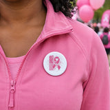PowHerful in Pink 2.5 inch sublimation button on a pink jacket at an awareness walk