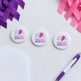 Domestic Violence and Breast Cancer Awareness sublimation buttons on a fundraiser table, short video