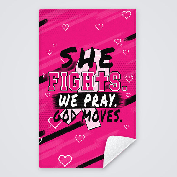 Pink Breast Cancer Awareness towel with She Fights We Pray God Moves and a pink ribbon, rally towel with the corner folded to show the white back