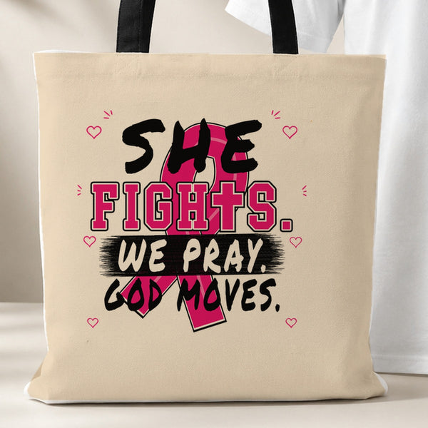 Beige She Fights We Pray God Moves Breast Cancer Awareness tote bag with black handles