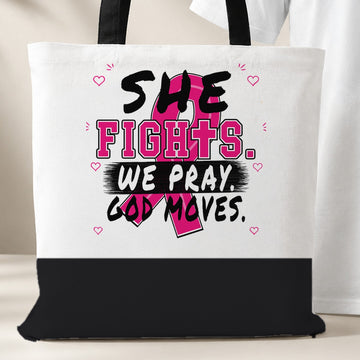 White She Fights We Pray God Moves Breast Cancer Awareness tote bag with black bottom panel and black handles